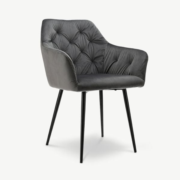 Dark gray upholstered armchair with button-tufted backrest and black metal legs