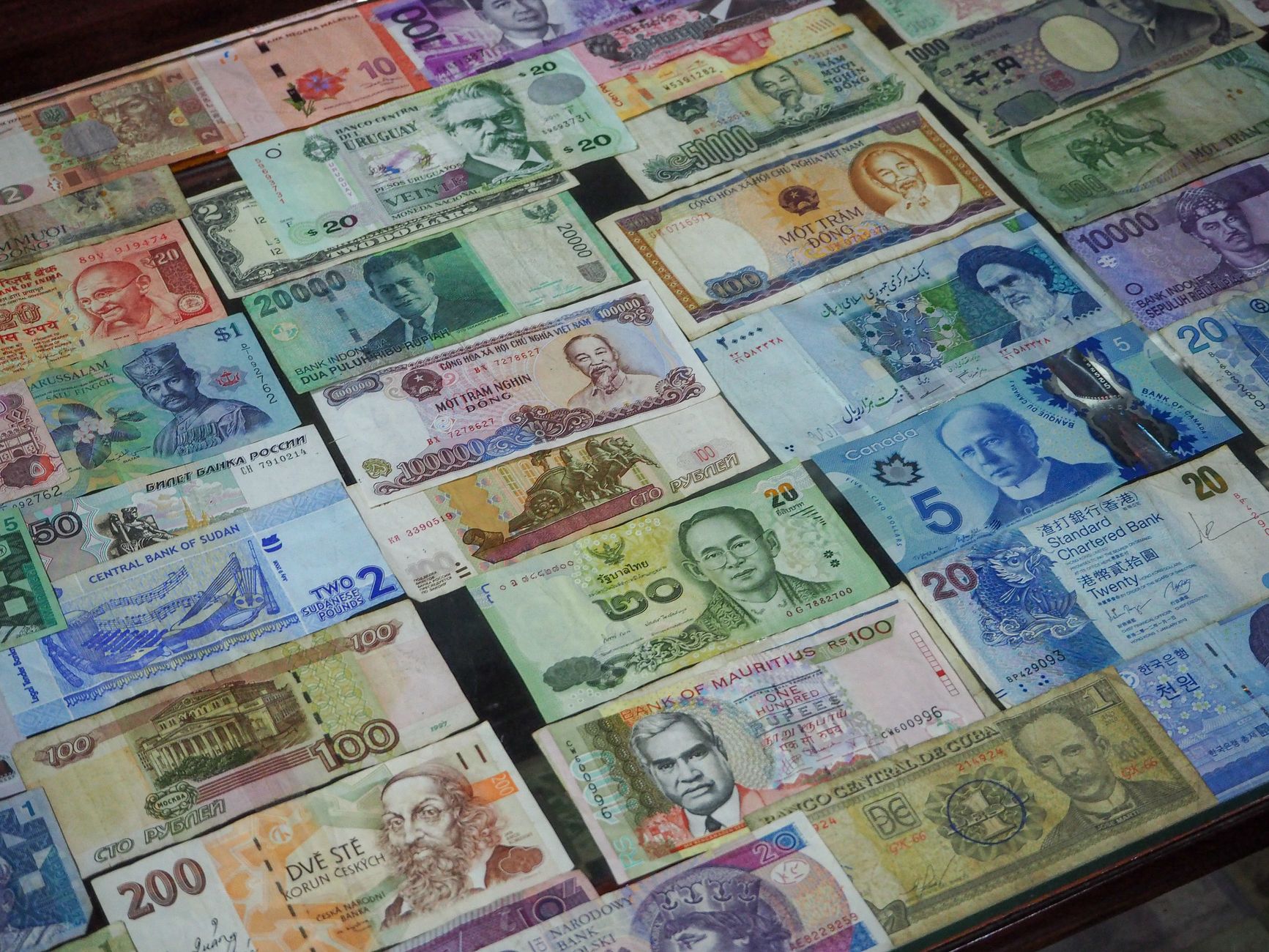 Verschiedene internationale Banknoten und Geldscheine aus unterschiedlichen Ländern liegen nebeneinander ausgebreitet.